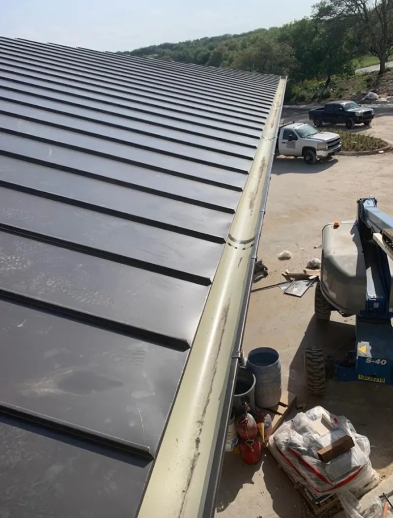 Standing seam panel and gutter detail on a metal roofing jobsite in D'Iberville